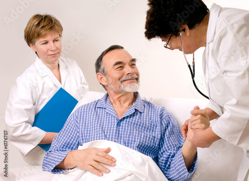 Photo: Two doctors with a patient Two doctors with a patient