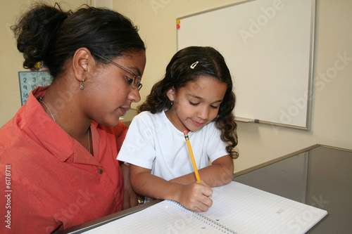 Young girl and teacher at computer