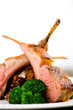 Roasted Rack of Lamb herb crusted on a white plate 