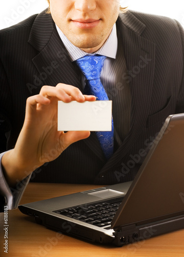 Photo: Business man with a blank card Business man with a blank card
