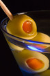 Cocktails, drinks, and alcohol in a colored glass at a bar