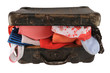 Old brown suitcase with clothes, isolated on white.