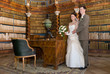 Bride and groom standing in ancient library