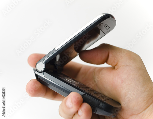 Photo: A hand hold a handset A hand hold a handset
