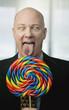 Businessman portrait with a brightly colered big lollipop