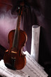 Old violin instrument and music sheet on dark