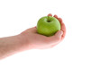Green apple in hand of man, isolated