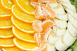 The cut bananas, oranges, tangerines,