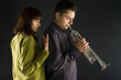The woman standing behind the trumpet man. 