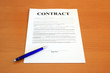 Photo: Contract document with blue pen (fictitious legal text) Contract document with blue pen (fictitious legal text)