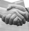 Photo en ligne au meilleur prix close up handshake with blue office building in background