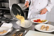 Chef preparing pasta on professional kitchen in restaurant Chef preparing pasta on professional kitchen in restaurant
