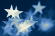 Blurred holiday background with star-shaped highlights. Blurred holiday background with star-shaped highlights.