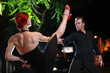 Couple dancing hot latin dance on a street at night Couple dancing hot latin dance on a street at night