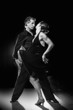 Couple dancing hot latin dance on a street at night Couple dancing hot latin dance on a street at night
