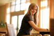 Beautiful young blond woman relaxing in sunny interior