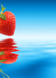 Red strawberry over blue water. Macro, close-up. Red strawberry over blue water. Macro, close-up.