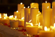 Many burning celebratory candles on a dark background