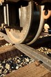A close up of a wheel on the train tracks.
