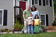 A family standing in front of their home
