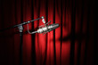 Vintage microphone with spotlight over a red curtain Vintage microphone with spotlight over a red curtain