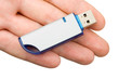 Flash drive in hand, isolated on white background Flash drive in hand, isolated on white background