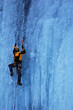 Man climbing a frozen waterfall