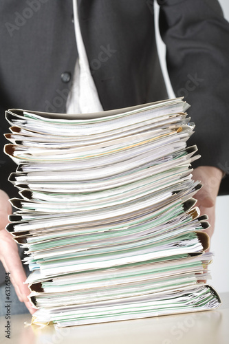 Photo: a businessman holding files a businessman holding files