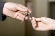  a man gives keys to a woman