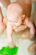 happy cute little baby girl taking bath