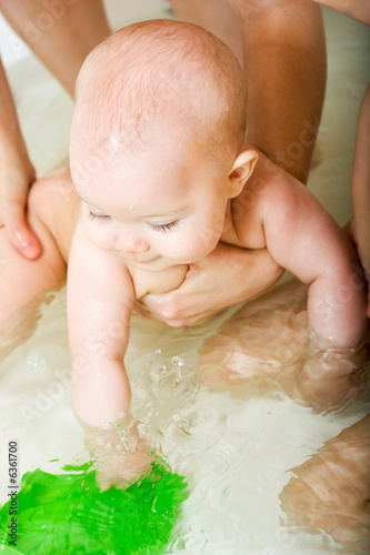 Photo: happy cute little baby girl taking bath happy cute little baby girl taking bath