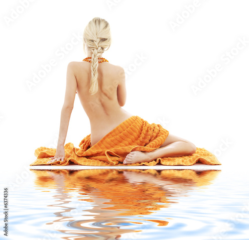 picture of beautiful lady with orange towels on white sand