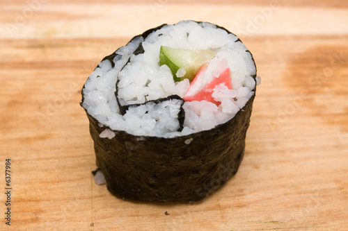 Photo: Closeup of sushi roll with crab meat and cucumber Closeup of sushi roll with crab meat and cucumber