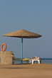 Parasol and sun bath on a beach