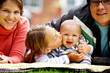 happy family smiling in a portrait of a mum and dad