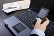 businesswoman holding mobile phone in office
