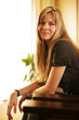 Beautiful young woman sitting in chair