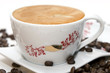 Cup of coffee and grains over white