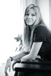 Beautiful young woman sitting in chair