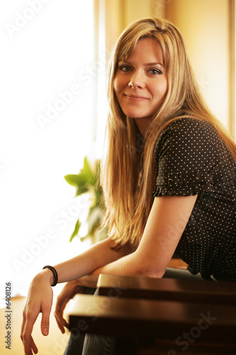 Beautiful young woman sitting in chair