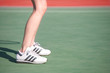 Legs of a young woman playing tennis in the sun Legs of a young woman playing tennis in the sun