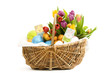 Wicker basket filled with easter eggs and tulips