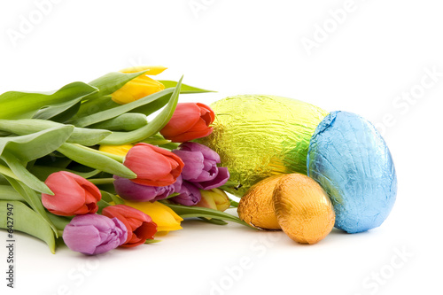 Chocolate easter eggs and fresh spring tulips