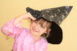 Five-year-old girl keeps witches hat in his hand.  Halloween.