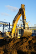 Hydraulic excavator at work. Shovel bucket against blue sky