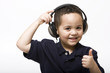 Young boy removing headphones giving thumbs up sign
