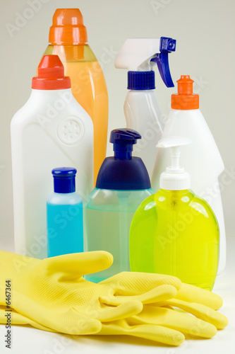 Photo: Colored plastic detergent bottles and yellow rubber gloves Colored plastic detergent bottles and yellow rubber gloves
