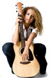 An attractive young teenage woman with an acoustic guitar 
