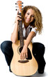An attractive young teenage woman with an acoustic guitar 