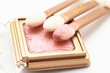 Pink foundation and three applicators on white Pink foundation and three applicators on white